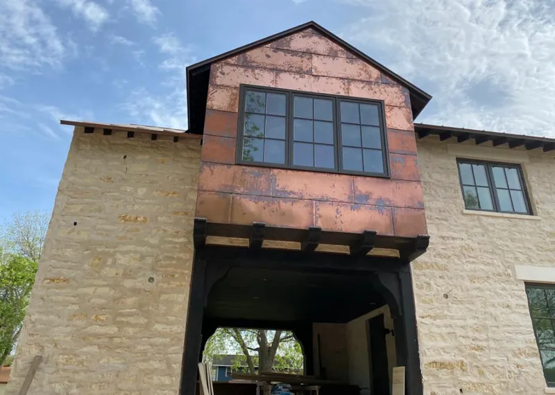 Copper metal panel facade on a stone building for Metal Roof Coating in Hailey